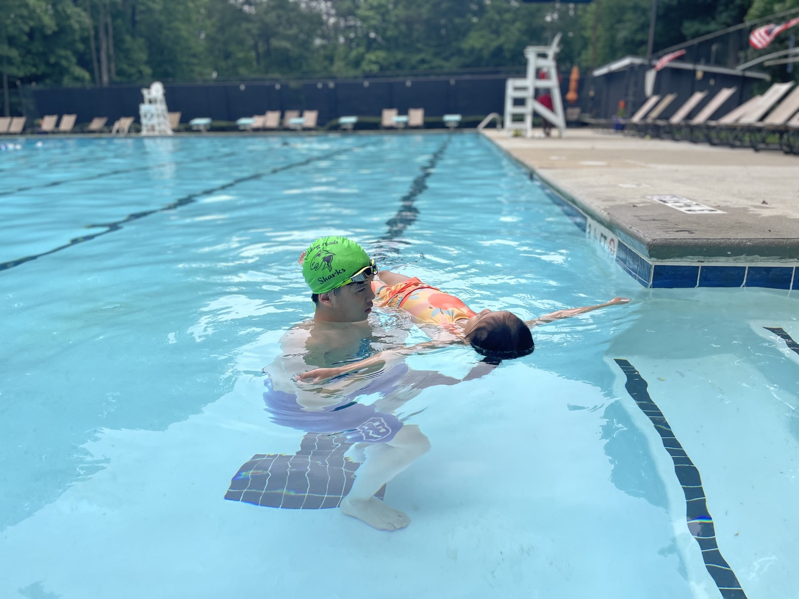 An instructor giving a swim lesson to a child