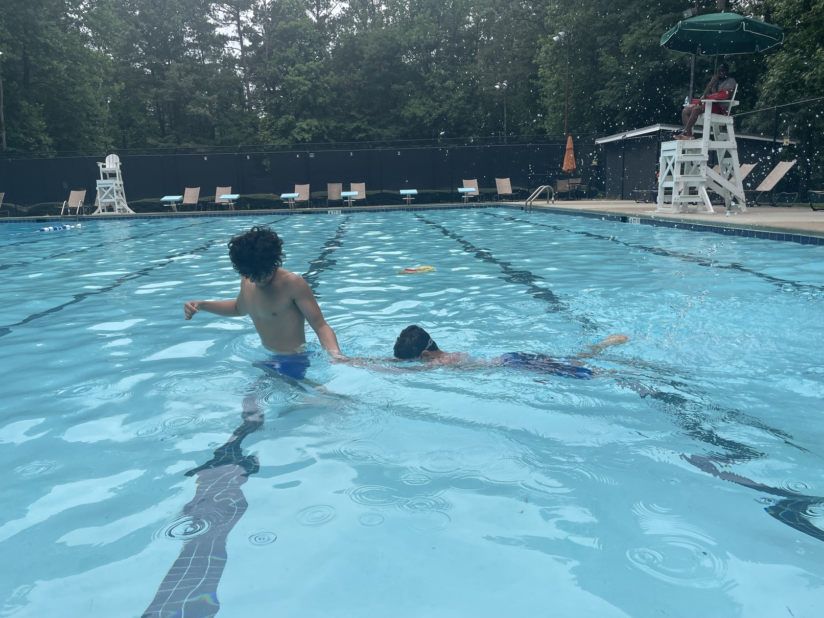 A child swimming underwater during a lesson